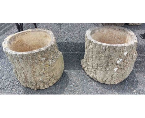 A pair of Sandford Stone concrete planters of tree trunk form