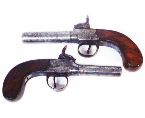 Two similar 19th Century percussion cap overcoat pistols one with chased decoration to the plate both with wooden grips
