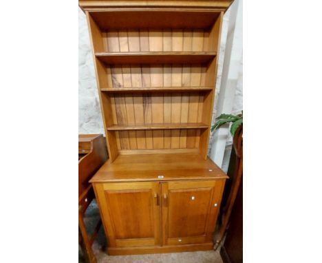 A 1.03m vintage polished oak two part dresser by Matthew McCann Furniture (Devon) with three shelf open plate rack over a bas