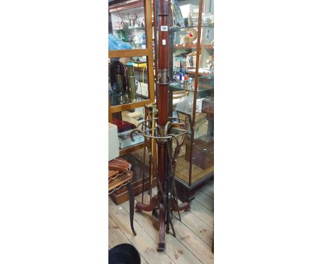 A reproduction brass mounted mahogany hat and stick stand with turned pillar, retaining rail and reeded tripod base - top mis