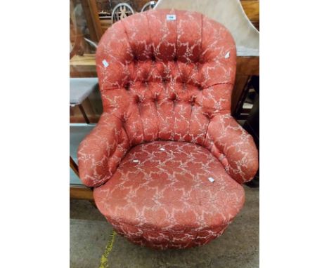 A late Victorian drawing room armchair with red floral tapestry upholstery, set on turned front legs with casters