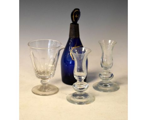 Blue glass 'Hollands' decanter and stopper, a 19th Century cut glass pouring beaker and a pair of glass candlesticks   Condit