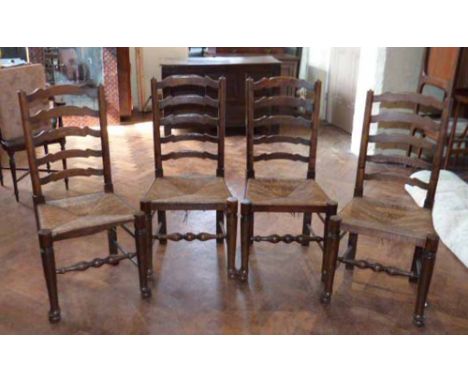 Four Lancashire style ladder-back rush seated chairs. Condition Report: see terms and conditions.