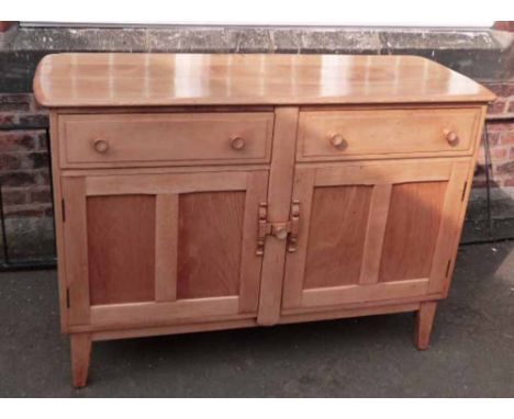 Ercol sideboard enclosing two frieze drawers and two cupboards to lower portion. Condition Report: see terms and conditions.
