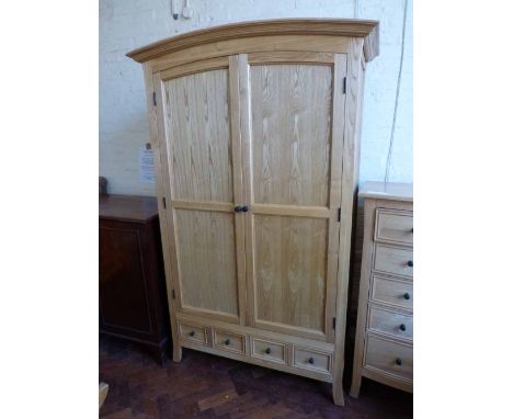 Ash "Halo" furniture two door wardrobe with two drawers to base 112cm wide. Condition Report: see terms and conditions.