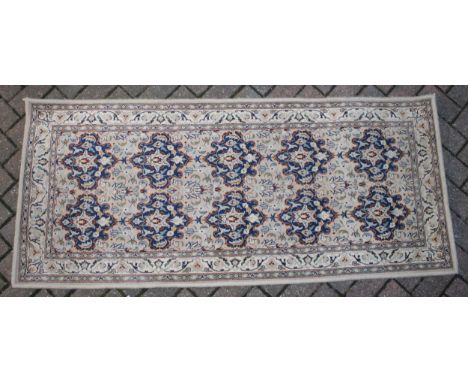 A Persian style runner / rug carpet in blues and creams. Dimensions 182cm x 80cm.