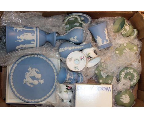A collection of Wedgwood Jasperware items to include vases, bud vases, lidded pots, trinket trays and pin dishes in colours W