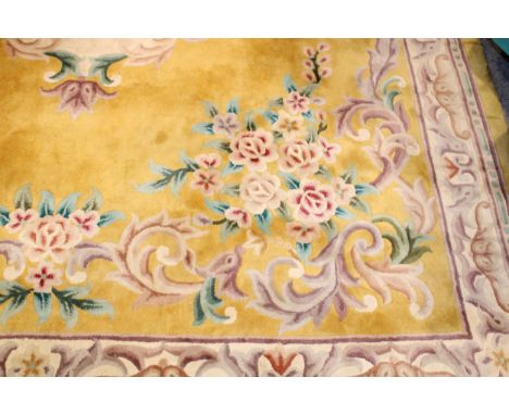 A large Chinese wool carpet in yellow with cream with turquoise. Dimensions 282cm x 255cm.