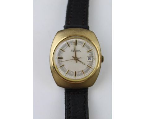 A vintage gentleman's Smiths Baton Swiss Made day date movement watch. Gold tone case on brown leather strap. White circular 