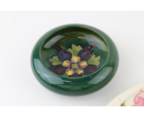 A Moorcroft bowl in the 'Clematis’ pattern together with an ashtray in the 'Magnolia' pattern. (2)  Of first quality with no 
