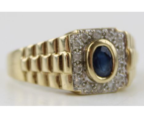 A vintage gents 9ct gold ring set diamonds and sapphire. Ring size Z. Weight 6.3g.