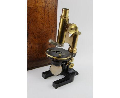An early c20th brass &amp; steel microscope possibly by Wray, London with spare lenses in the original wooden case c1900  the