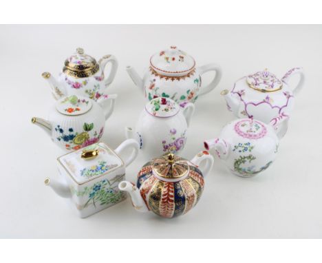 A collection of Franklin Mint Victoria &amp; Albert small teapots to include Meissen, Mennecy, Furstenburg and others (8).  I