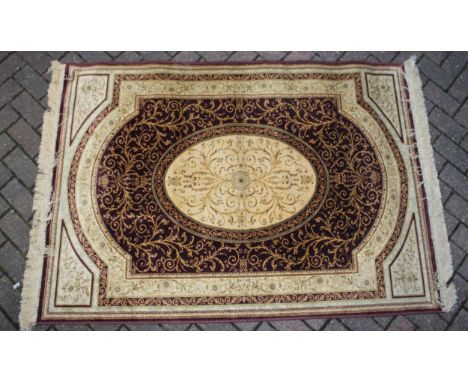 A Persian style carpet in crimsons and creams. Dimensions 175cm x 119cm.
