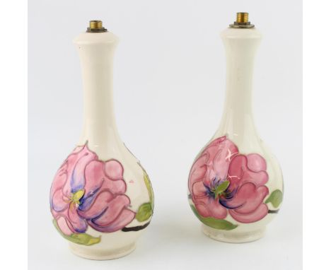 A pair of Moorcroft lamp bases in the 'Magnolia' pattern. Height 23cm.  Of first quality with no obvious signs of restoration