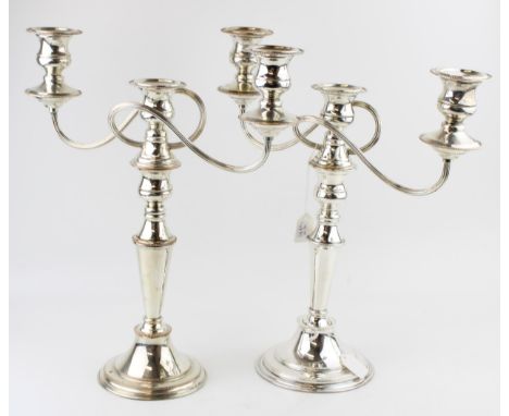 A pair of silver plated three branch candelabra with reeded scroll arms, 39.5cm tall (2).