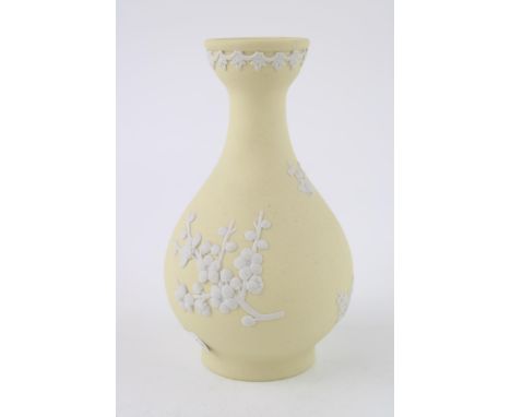 A Wedgwood Jasperware Prunus bud vase in Primrose Yellow. Height 12.5cm.  Of first quality and in good clean condition with n