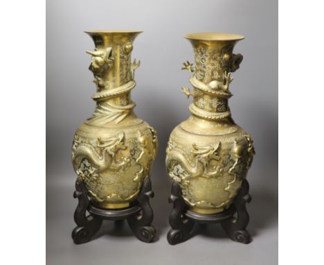 A pair of large Chinese bronze vases on stands,45.5 cms high including stands