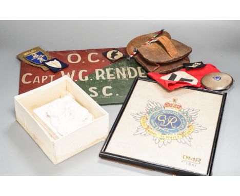 A group of WWI and WWII militaria badges, buttons, two swagger sticks, a Third Reich armband and a World War I German POW ins