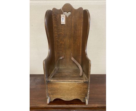 An 18th century oak child's rocking commode chair, width 33cm, depth 50cm, height 70cm