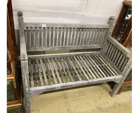 A small weathered teak slatted garden bench, length 114cm, depth 56cm, height 90cm