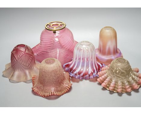 Six various cranberry glass lamp shades, two with opalescence, largest 16 cms high.