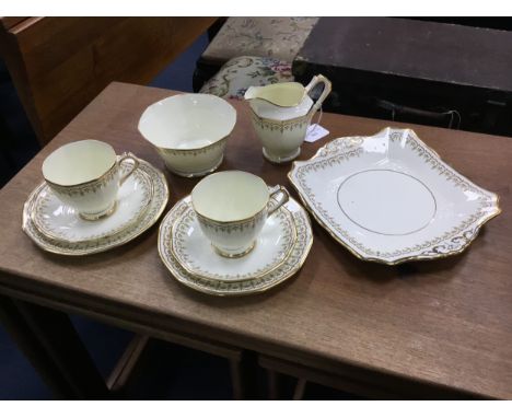 TUSCAN CHINA TEA SERVICE, with green enamel and gilt decoration, comprising twelve cups, twelve saucers, twelve side plates, 