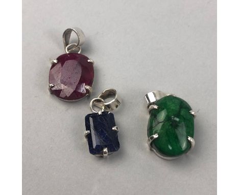 THREE GEM SET PENDANTS, including a 16.00 carat ruby, 22.00 carat emerald and a 9.00 carat sapphire, each in silver (3)