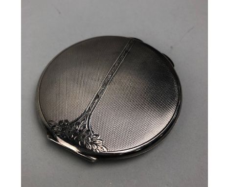 SILVER ENGINE TURNED CIRCULAR COMPACT, the cover engraved with flowerheads, Birmingham 1955