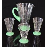 A retro green and clear glass lemonade set comprising a jug and three glasses with cut decoration of
