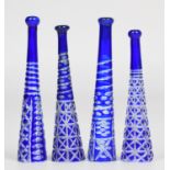 Four flash overlaid blue cut glass cheroot holders, largest 8cm long.