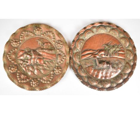 WW2 North Africa campaign interest pair of copper trench art wall plates, one depicting a camel with desert scene beyond, the