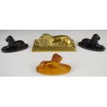 Four various 19thC paperweights all in the form of recumbent lions, three pressed glass, the
