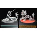 Swarovski Crystal glass dragon and unicorn, both on display plinths, each base 15cm long.