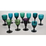 Eleven Bristol style late 18th/ early 19thC green and amethyst glass drinking glasses, some with