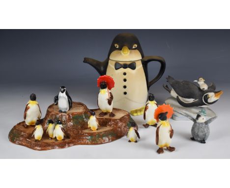 A collection of novelty penguin figures including Beswick penguins with umbrellas, Franklin Mint, a teapot etc, tallest 22cm