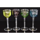 Four Moser flash overlaid hock glasses, each with engraved decoration of birds, cut stems and