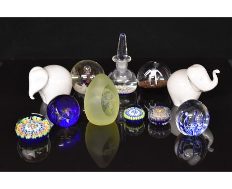 Eleven glass paperweights including Perthshire scent / ink bottle, Caithness Dewdrop Orchid, Wedgwood elephants etc