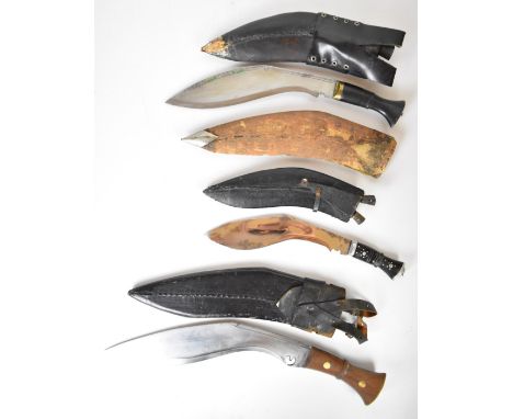 Three kukri knives, all with scabbards, two with kardas and chakmaks, together with a wooden scabbard.&nbsp;PLEASE NOTE ALL B