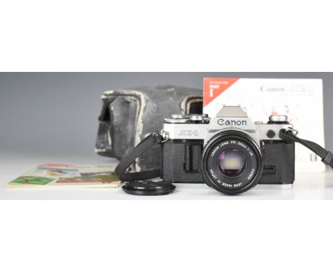 Canon AE-1 35mm SLR camera, with 50mm 1:1.8 lens and instruction manual