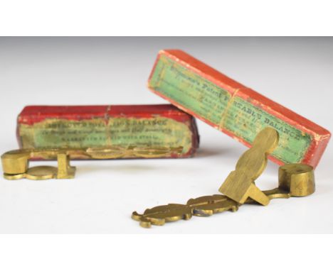 Two rocker type sovereign balances or scales, both in original boxes, one marked Simmons to box, the balances marked Taylor a
