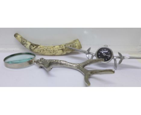 A magnifying glass with antler shaped handle, an aeroplane shaped desk clock and a reproduction scrimshaw horn