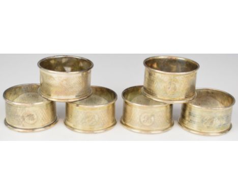 Six hallmarked silver napkin rings with engine turned decoration, weight 83g