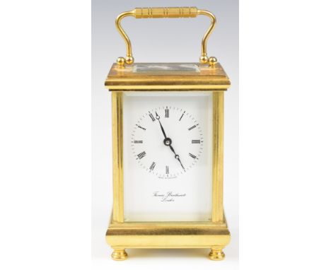 Thomas Braithwaite London gilt brass cased carriage clock with bevelled glass, raised on four turned feet, height including h