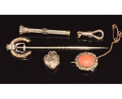 A 9ct rose gold clip, Victorian yellow metal stick pin in the form of a horseshoe and stirrup, Victorian brooch set with cora