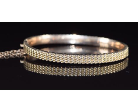 A 9ct rose gold bangle with curb link decoration, Birmingham 1889, 9.1g, 4.9 x 5.8cm&nbsp;