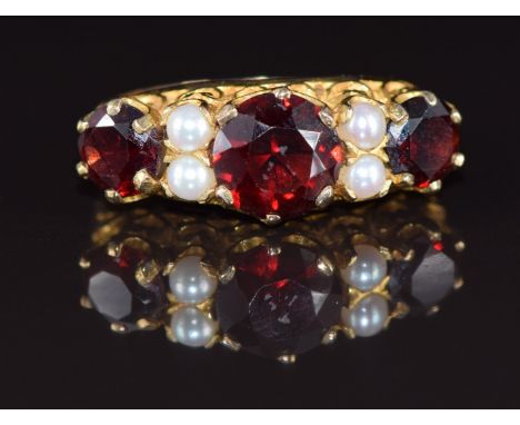 A 9ct gold ring set with garnets and pearls, 3.1g, size L