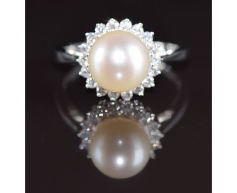 A 9ct white gold ring set with a cultured pearl surrounded by diamonds, 3.3g, size M