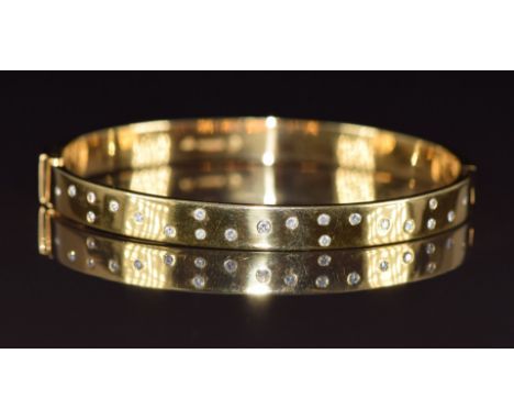 An 18ct gold bangle set with diamonds, 31.7g, 5.8 x 5cm