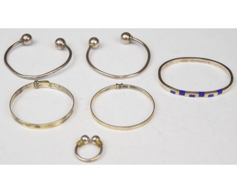 Five silver bangles, one set with lapis lazuli, and a silver ring&nbsp;